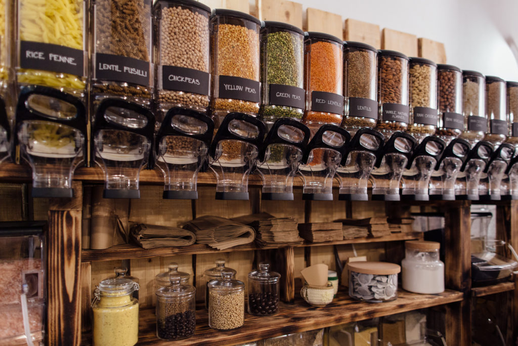 Shelf with food containers in package free organic shop.